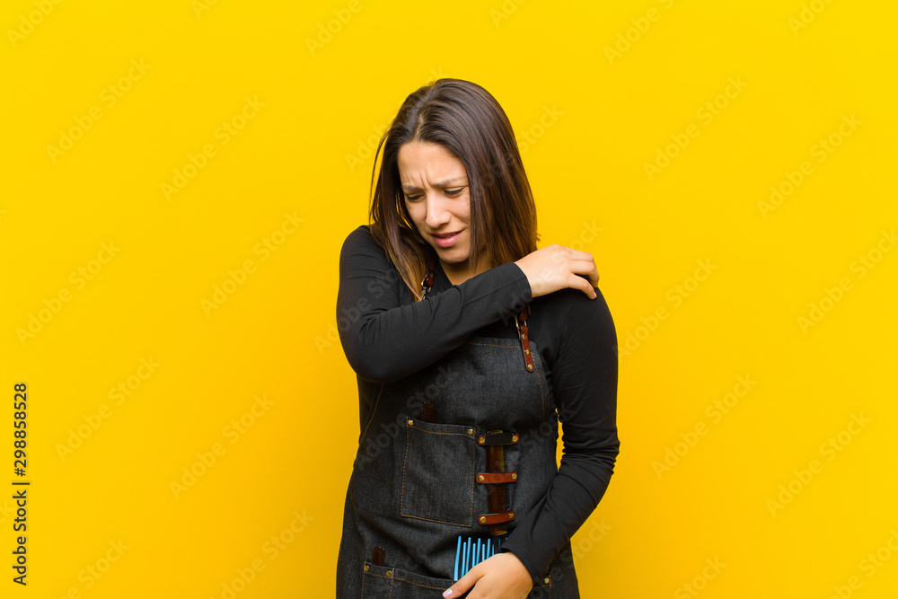 Φωτογραφία hairdresser woman feeling anxious, ill, sick and unhappy, suffering a painful st