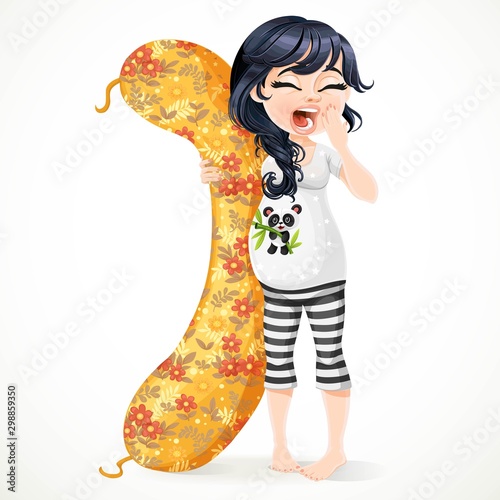 Beautiful sleepy pregnant brunette woman in black and white pajamas with a long pillow for pregnant woman isolated on white background