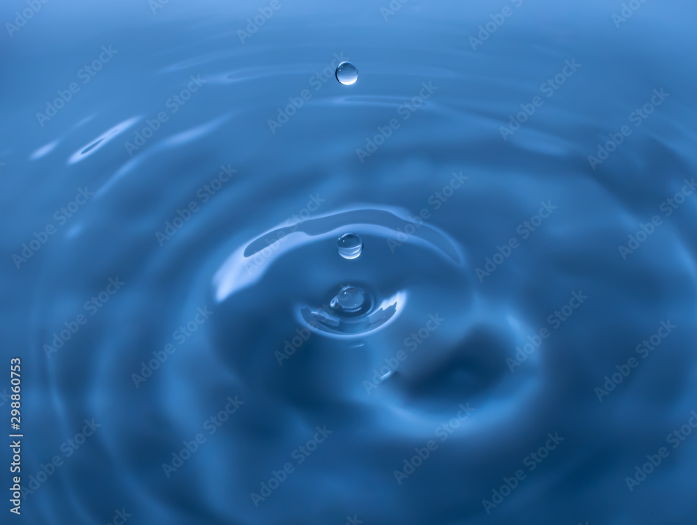 Water drop falling and drips on mirror. Water drop splash and make perfect circles on water surface. Water drop falling and drips on mirror. Water drop splash and make perfect circles on water surface.