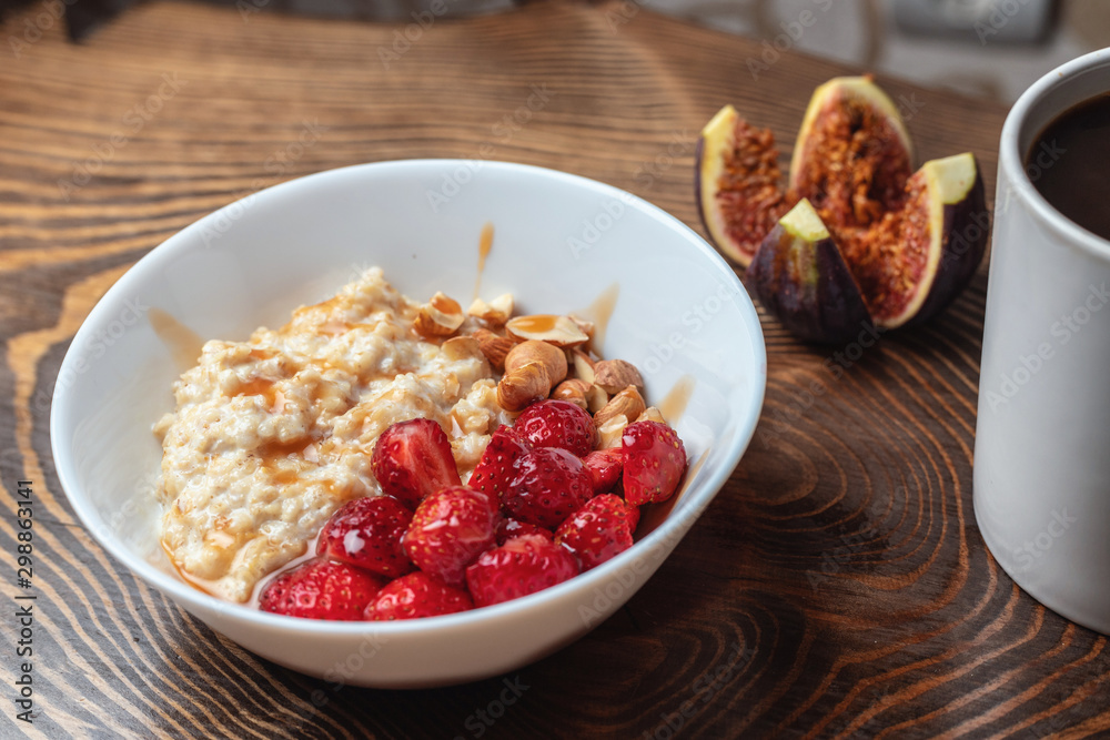 Breakfast oatmeal porridge with fruits berries and coffee cup. Healthy breakfast concept. Breakfast oatmeal porridge with fruits berries and coffee cup. Healthy breakfast concept.