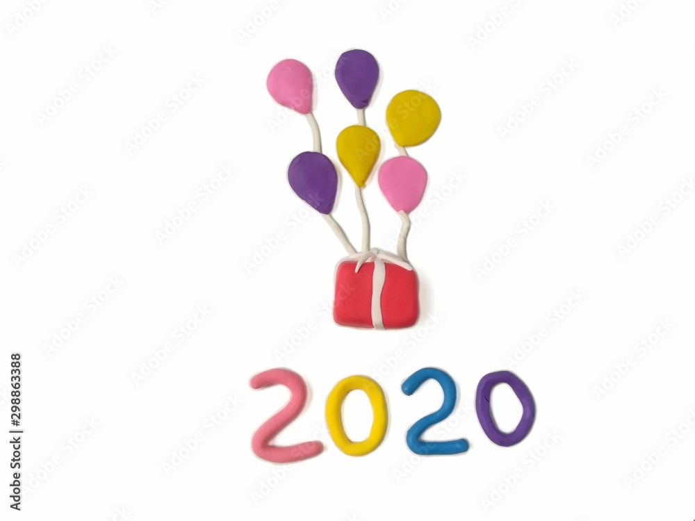 Red gift box floating in the sky with colorful balloon and number 2020 year text are handmade from plasticine clay on white background, cute shape are dough 