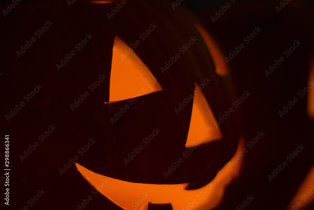 Classic laughing jack-o-lantern carved with candle light