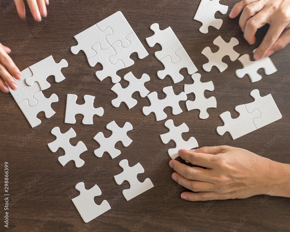 Autism and autistic ,child putting puzzle together. Hands of children  students and teacher holding pieces of jigsaw as a symbol for teamwork in  school. Business plan concept. Stock Photo | Adobe Stock