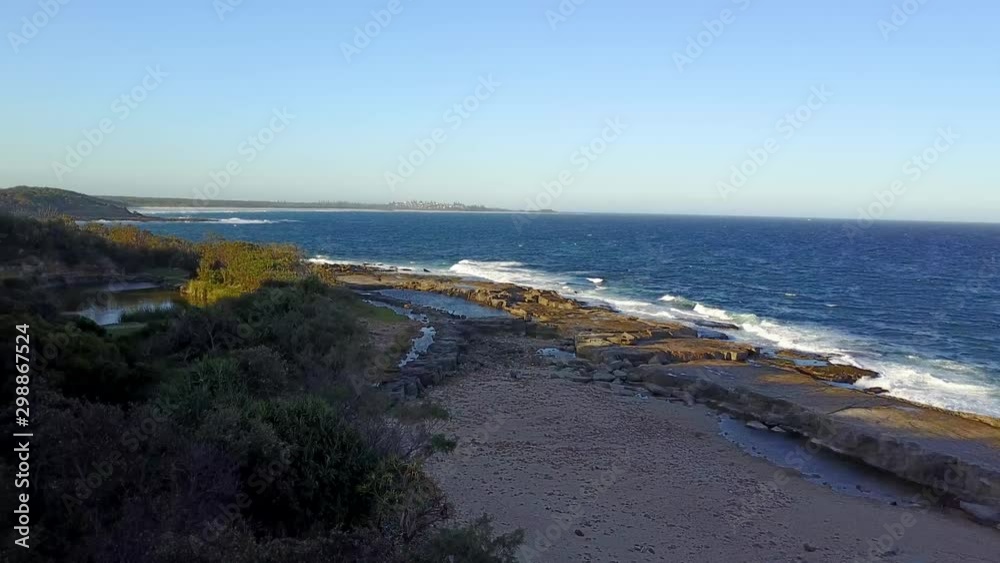 Aerial Drone Panning Around A Rocky Shoreline In Yamba Australia With Rock Pools And Lush Green Forest Aerial Drone Panning Around A Rocky Shoreline In Yamba Australia With Rock Pools And Lush Green Forest