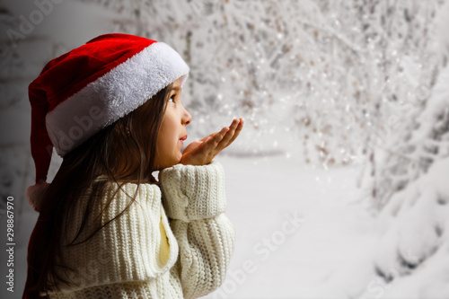 winter time! Happy little girl blowing on snow © Angelov