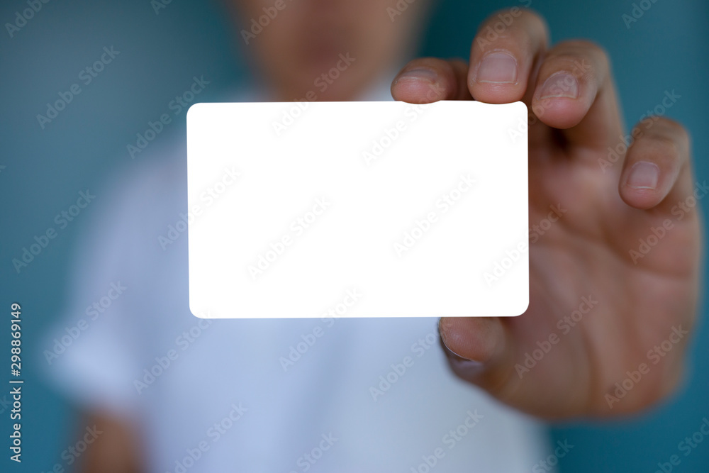 Hand holding a blank piece of paper. Close up white business card. Hand holding a blank piece of paper. Close up white business card.