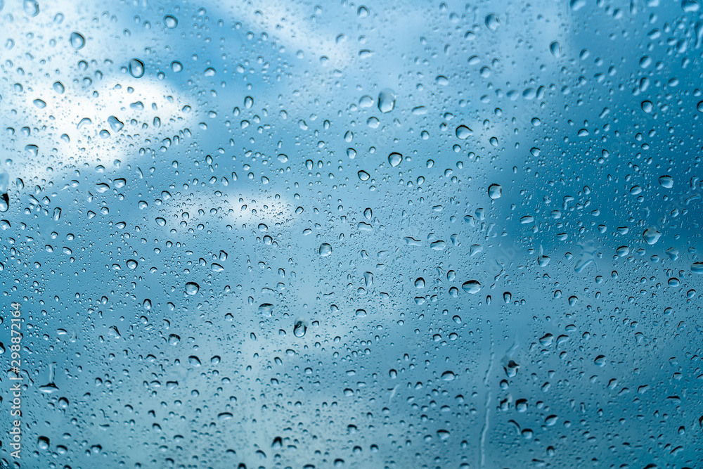 Fresh water drops after raining on blue glass window background in car. Fresh water drops after raining on blue glass window background in car.