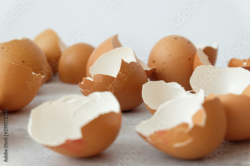 View of broken brown eggs on grey background
