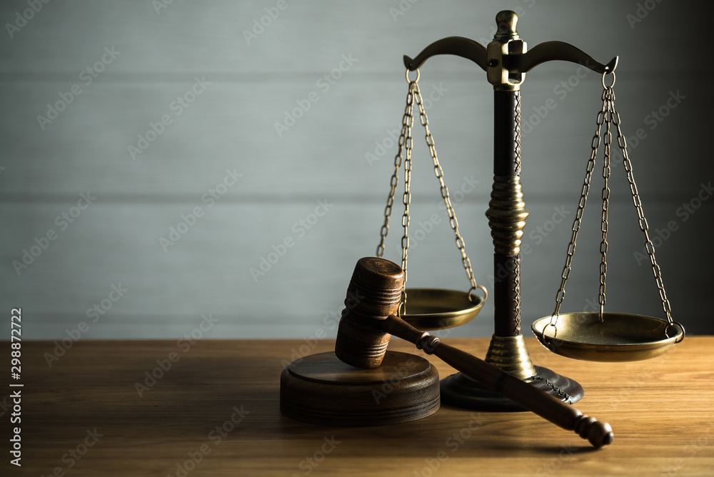 Wooden judge`s gavel. Themis figurine. The criminal law. Low concept. Wooden judge`s gavel. Themis figurine. The criminal law. Low concept.