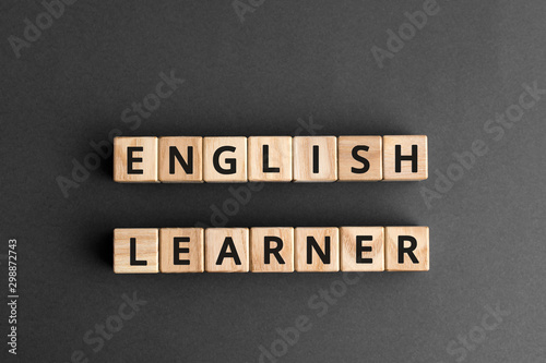 English learner - phrase from wooden blocks with letters, student  english learner concept, top view gray background