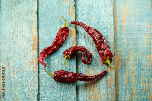 Dried red chilli peppers on old wooden background. Healthy eating concept.