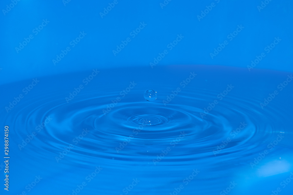 Water sculpture created by a falling drop, with a circular drop bounce on top Water sculpture created by a falling drop, with a circular drop bounce on top