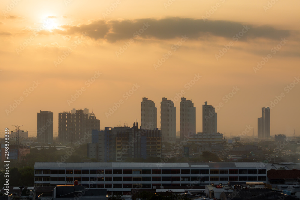 Beautiful aerial cityscape view of the skyline of Jakarta (seen from Kota tua aka old town or Batavia), Indonesia, at sunrise