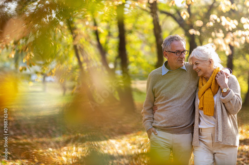 Happy senior couple in autumn park photo