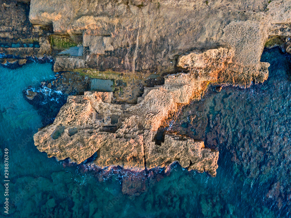 Aerial view of rocks in the sea. Overview of the seabed seen from above, transparent water. Seabed. Pizzo Calabro, Calabria, Italy