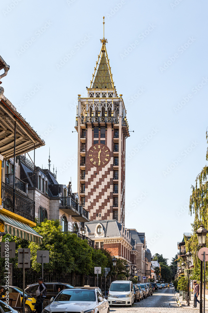 Fototapeta premium City clock tower stands on Batumi Piazza square in the old part of the Batumi city - the capital of Adjara in Georgia