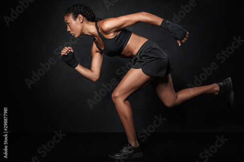 Image of african american woman in sportswear and hand wraps running © Drobot Dean