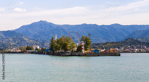 Cargo port with a lighthouse on the Black Sea embankment of Batumi city - the capital of Adjara in Georgia
