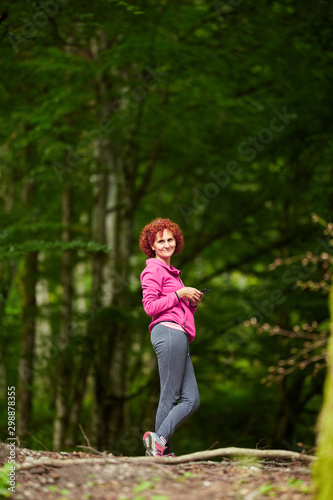 Woman trekking through forest