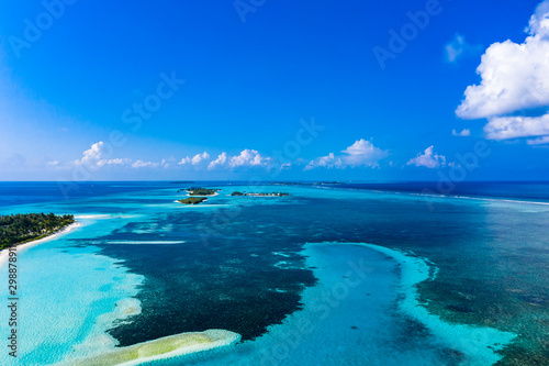 Fototapeta Naklejka Na Ścianę i Meble -  Aerial view, lagoon of a Maldives island with corals from above, South Male Atoll, Maldives
