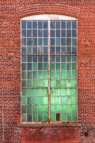 veertical background of an industrial factory window set in a brick wall photo