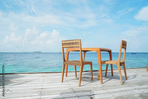Outdoor terrace with Empty  wooden table and chair with Sea view of Indain ocean  Maldives background