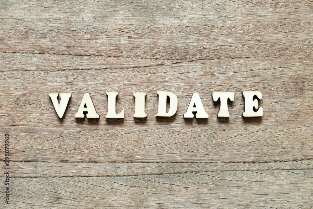 Letter block in word validate on wood background Letter block in word validate on wood background