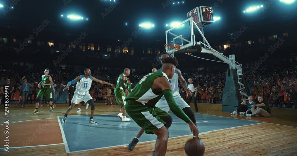 Basketball players on big professional arena during the game. Tense moment of the game. Celebration