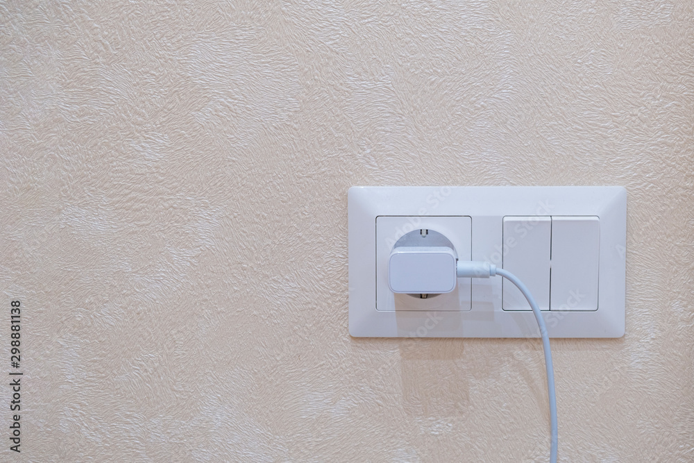 Electric socket with connected pnone charger and two-button switch on the wall Electric socket with connected pnone charger and two-button switch on the wall
