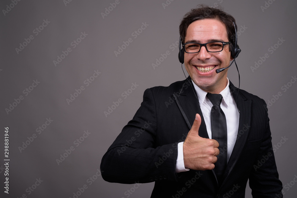 Handsome Persian businessman working as call center representati Handsome Persian businessman working as call center representati