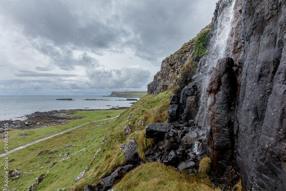 Waterfall overlooking the cliff and Scottish sea on the island of Canna, The Hebrides