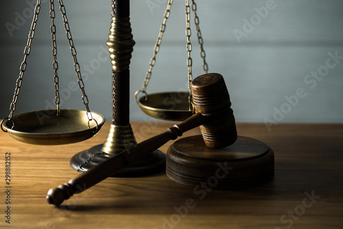 Wooden judge`s gavel.  Themis figurine. The criminal law. Low concept.