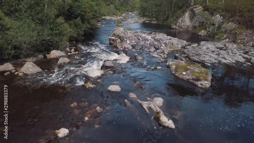 View of a river in a giant forest. Green scottish landscape, highlands