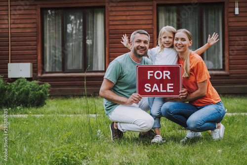 Fototapeta Happy family selling their house in countryside