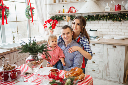 Happy family at the kitchen during Christmas morning