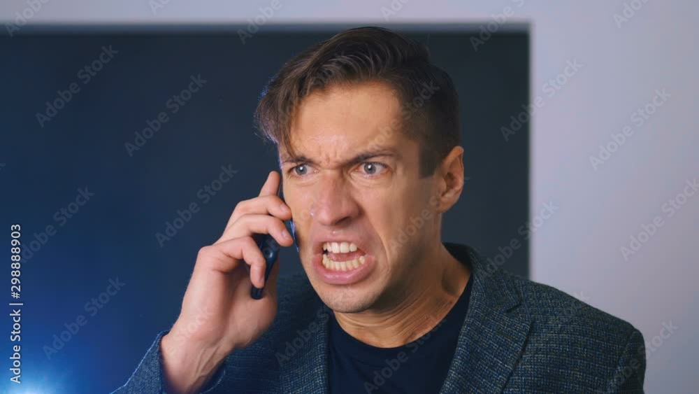 Angry business man screaming at the interlocutor, talking on a cell phone. Angry business man screaming at the interlocutor, talking on a cell phone.