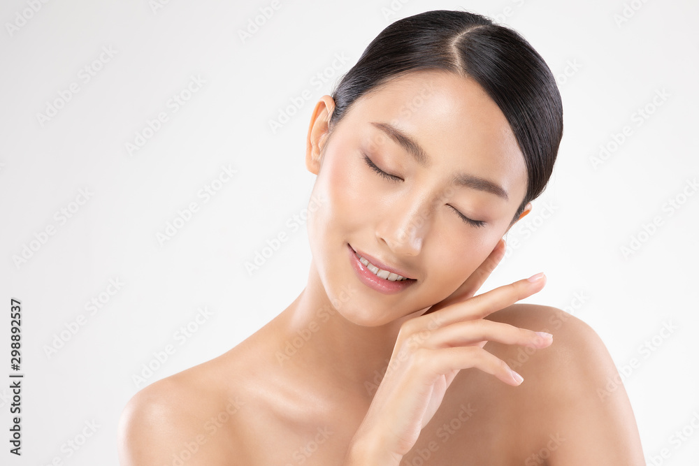 Beautiful Asian young woman close her eyes touching soft cheek smile with clean and fresh skin Happiness and cheerful with positive emotional,isolated on white background,Beauty and Cosmetics Concept