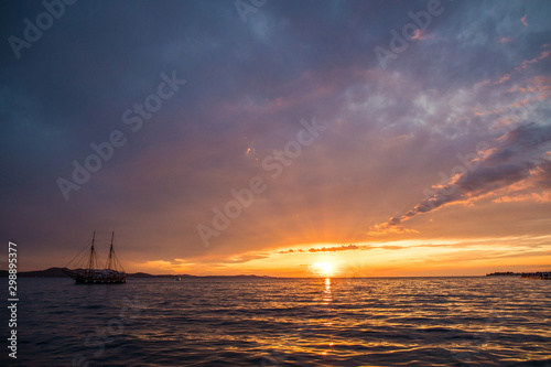 Zadar, Croatia - July, 2019: Old seaboat over Sunset in Zadar, Croatia