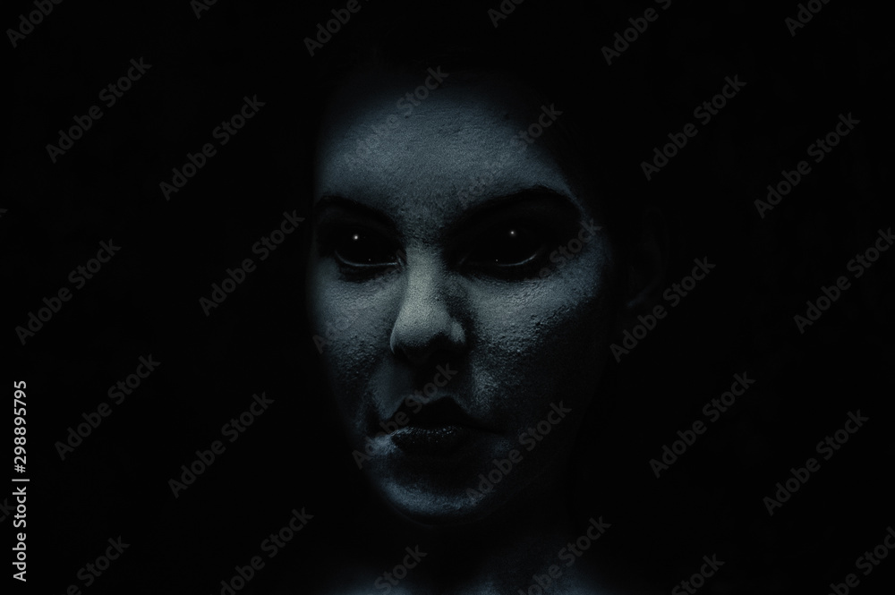 Scary and frightening demonic woman face with black eyes in the dark ...