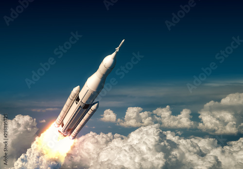Fototapeta Naklejka Na Ścianę i Meble -  Flight Of Big Carrier Rocket Above The Clouds