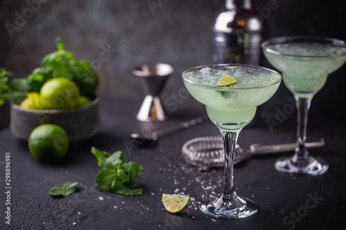 margarita cocktail with lime in a glass on dark background photo