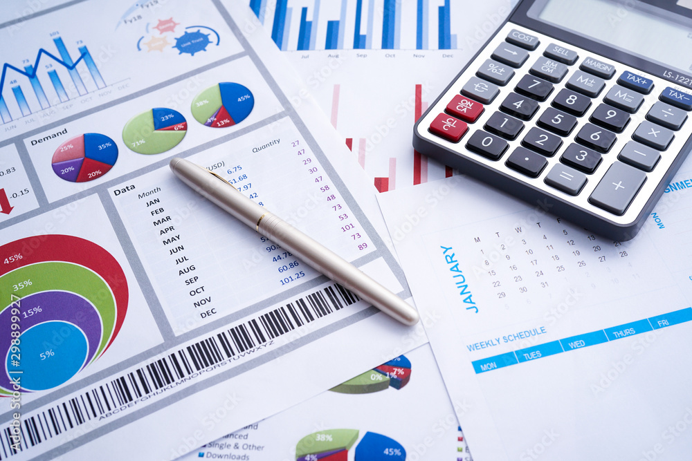 Business and finance with analytical study on market trend or demand with document on paper, calculator, and a pen Business and finance with analytical study on market trend or demand with document on paper, calculator, and a pen