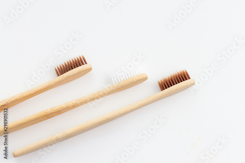Natural bamboo set of toothbrushes on whita background. Flat with a bamboo handle. Eco concept health and care