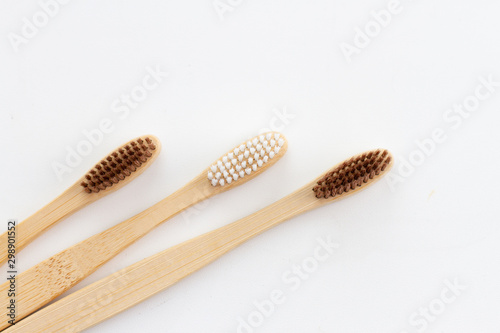 Natural bamboo group of toothbrushes on whita background. Flat with a bamboo handle. Eco concept health and care