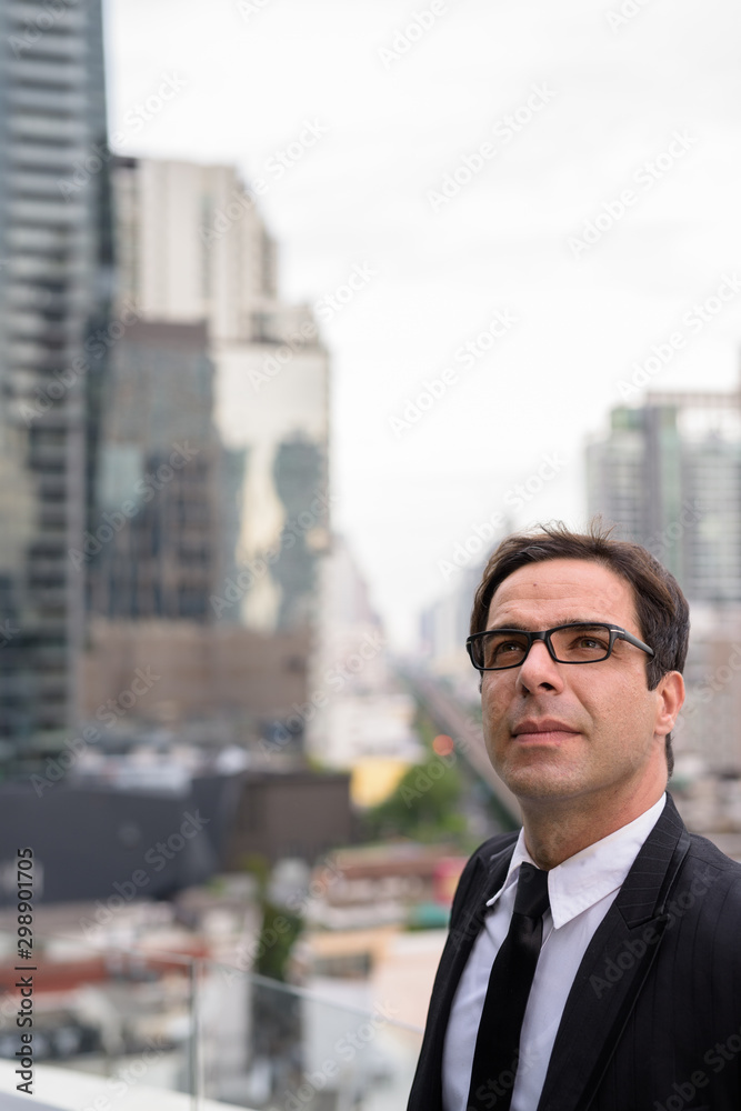 Handsome Persian businessman against view of the city