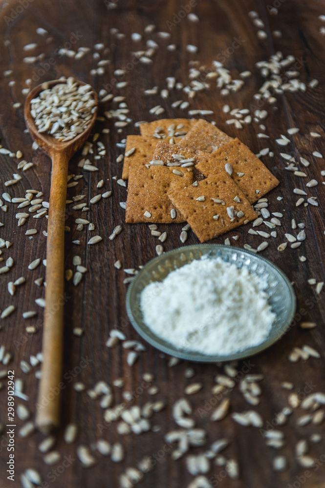 wheat crackers shooted with different vegetables,groats,honey,seeds,salt on different surfaces wheat crackers shooted with different vegetables,groats,honey,seeds,salt on different surfaces