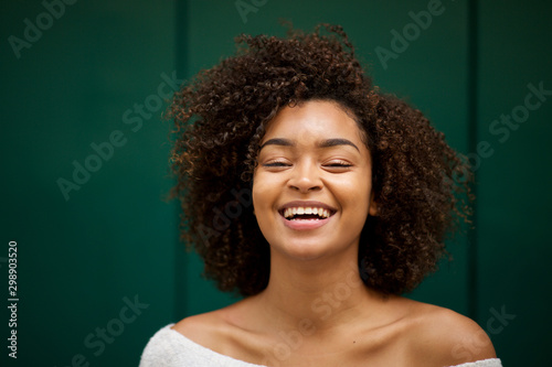 Close up front of young smiling african american woman with curly hair