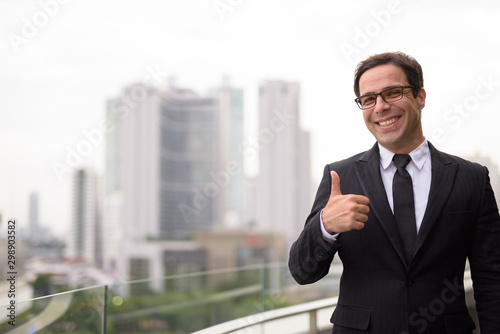 Handsome Persian businessman against view of the city