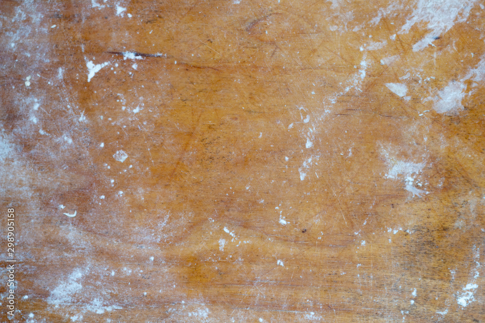 Old cutting board sprinkled with flour. Tools for cooking. Wood background. Old cutting board sprinkled with flour. Tools for cooking. Wood background.