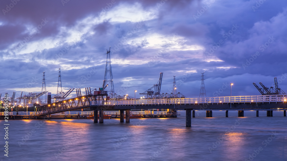 Pier in river Scheldt with container terminal on the background, Port of Antwerp, Belgium. Pier in river Scheldt with container terminal on the background, Port of Antwerp, Belgium.